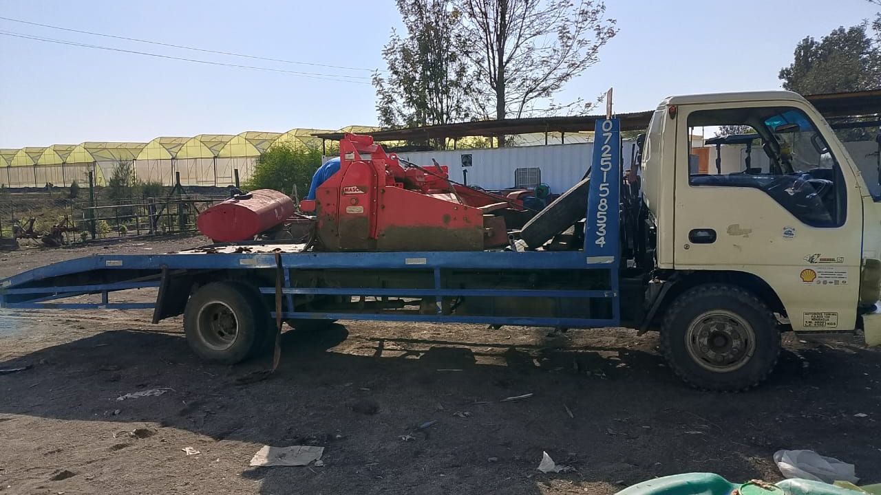 Roadside assistance technician changing flat tire